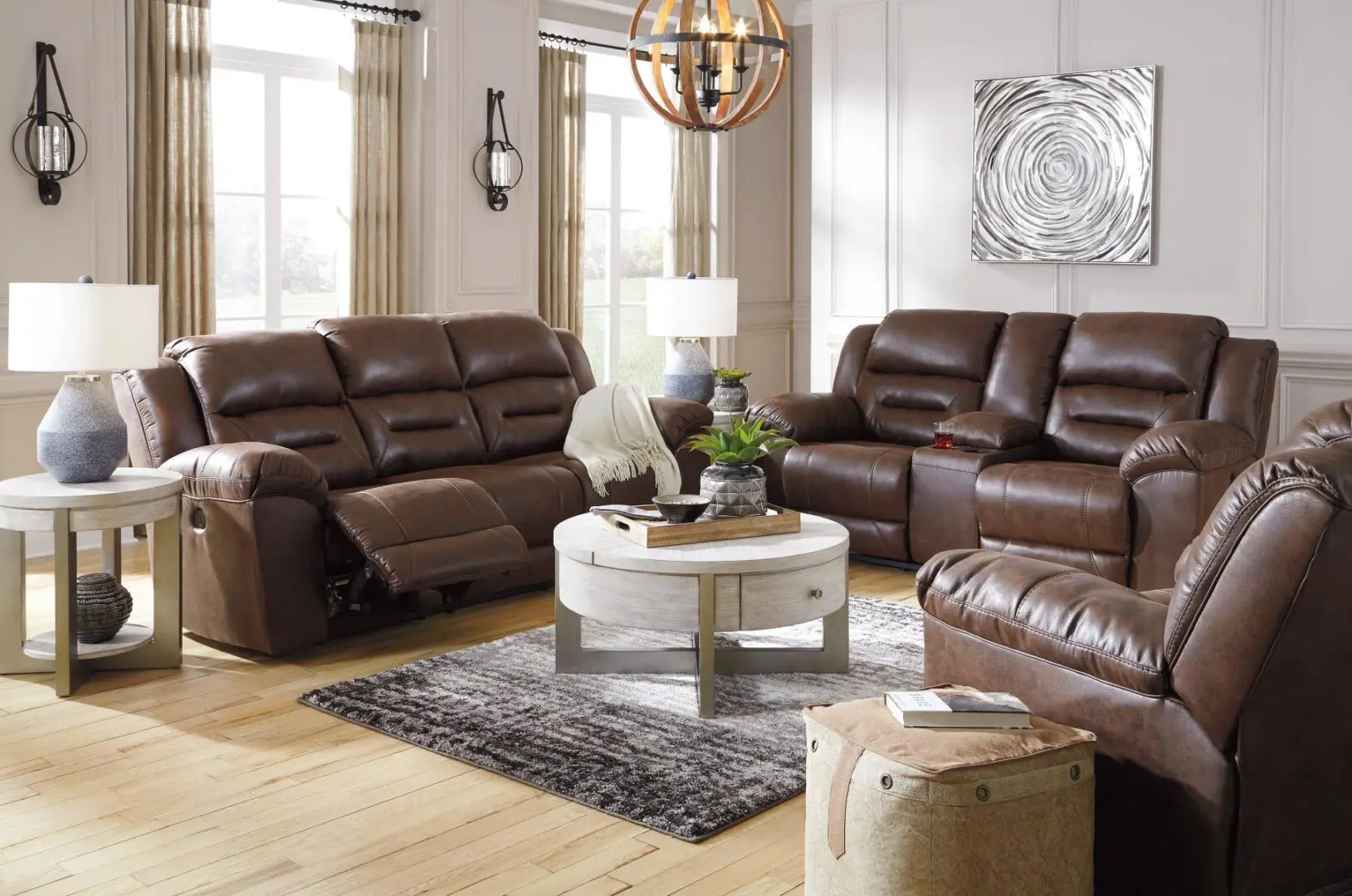 A living room with brown leather furniture and a white coffee table.