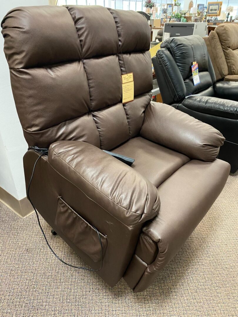 A brown leather recliner with an electric control.